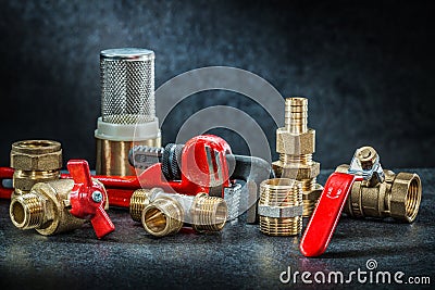 Set of plumbing pipe connectors on dark background Stock Photo