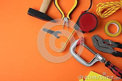 Set of repair tools on orange , flat lay. Space for text Stock Photo