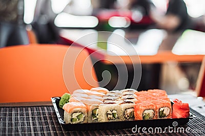 Set of rolls from California and Philadelphia in the background of a cafe. Stock Photo