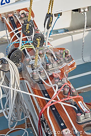 Set of ropes for management of the sailboat of different color, the signature to each rope, rollers, levers, carbines Stock Photo