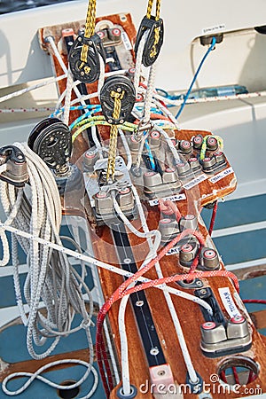 Set of ropes for management of the sailboat of different color, the signature to each rope, rollers, levers, carbines Stock Photo