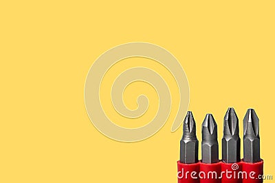 Set of screwdriver bits. metal repair accessories isolated on yellow background Stock Photo