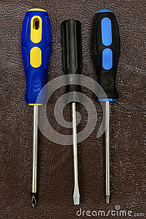 Set of screwdrivers three hand-held fixing tools home repairman on dark background design base Stock Photo