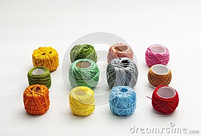 Set of several spools of thread of different colors on a white background. Stock Photo