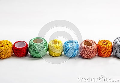 Set of several spools of thread of different colors on a white background. Stock Photo