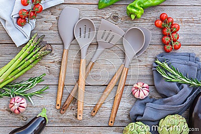 Set of silicone kitchen utensils on a wooden table Stock Photo