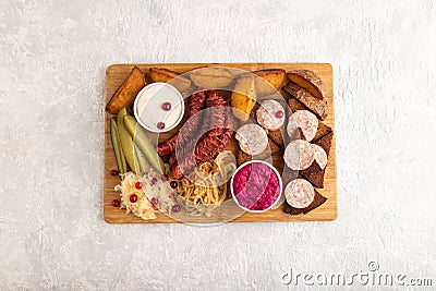 Set of snacks: sausages, toast, sauerkraut, marinated onion and cucumber, baked potato. Top view, copy space Stock Photo