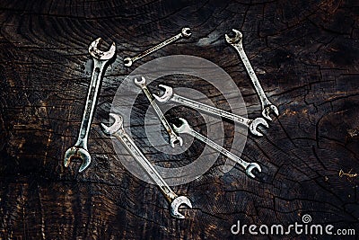 Set of spanners on a dark wooden background. Stock Photo