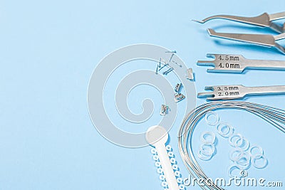 A set of special tools for an orthodontist to install braces for a patient. Orthodontic arcs, ligature, locks, positioner, Stock Photo