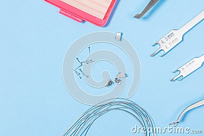 A set of special tools for an orthodontist to install braces for a patient. Orthodontic arcs, ligature, locks, positioner, Stock Photo