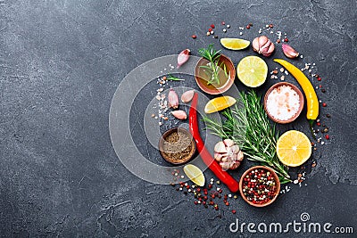 Set of spices and herbs on black stone table top view. Ingredients for cooking. Food background. Stock Photo