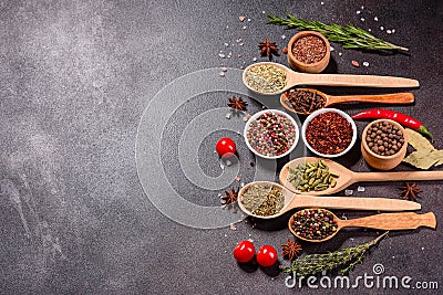 A set of spices and herbs. Indian cuisine. Pepper, salt, paprika, basil and other on a dark background Stock Photo