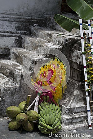 A set of spiritual offerings including bananas and coconuts in front a the stairs of a temple in Chiang Mai, Thailand. Stock Photo