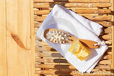 Set for a steam bath. Towel, soap and body brush. View from above. Bright sunshine and shadows Stock Photo