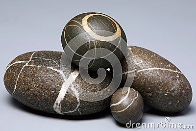 Set of striped rocks pebbles on grey background Stock Photo