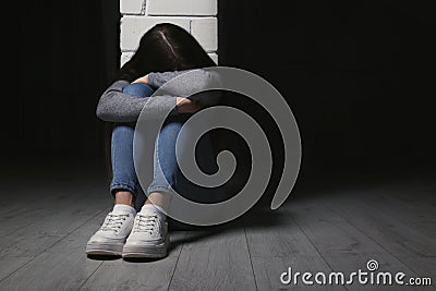 Set teenage girl sitting at column indoors. Space Stock Photo