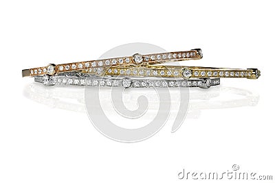 Set of three colored gold and diamond bracelets stacked Stock Photo