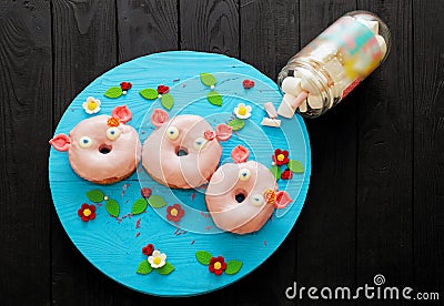 A set of three donuts in the form of pigs. sweets. glaze. delicious product Stock Photo
