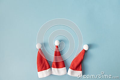 Set of three Santa Claus hats on a light blue background. Christmas or New Year concept. Minimalism. Copy Space Stock Photo