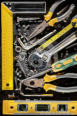 Tools, screws and nuts on a metallic background Stock Photo