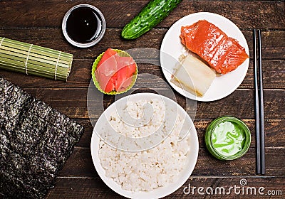 Set of traditional japanese food on a dark background. Sushi rolls, nigiri, raw salmon, rice, pickled ginger. Asian food frame. M Stock Photo