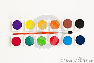 Set of twelve colorful watercolors with brush on a white surface Stock Photo