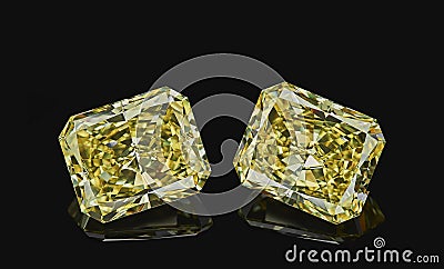 Set of two luxury yellow transparent sparkling gemstones emerald cut shape diamonds isolated on black background Stock Photo