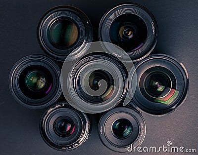Set of various DSLR lenses with colorful reflections Editorial Stock Photo