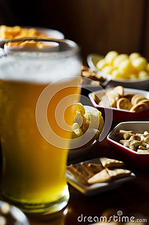Set of various snacks, pint of lager beer in a glass, a standard set of drinking and eating in a pub Stock Photo