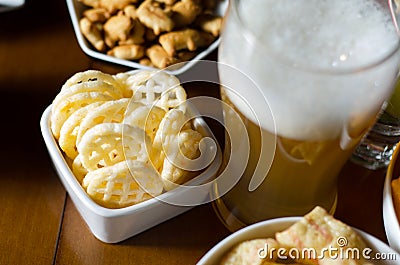 Set of various snacks, pint of lager beer in a glass, a standard set of drinking and eating in a pub Stock Photo