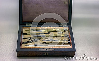 Set of vintage drawing metal compasses in wooden box Stock Photo