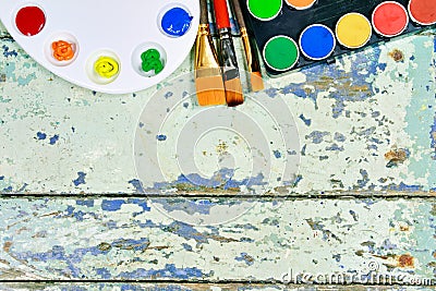 Set of watercolor aquarell rainbow paints and brushes on vintage Stock Photo
