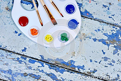 Set of watercolor aquarell rainbow paints and brushes on vintage Stock Photo
