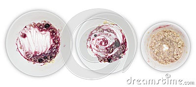 A set of white plates with porridge and blueberry jam leftovers on white background. Messthetics aesthetic concept. A pho Stock Photo