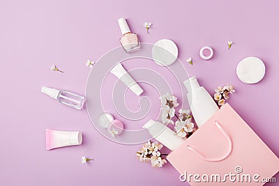 Set of woman`s cosmetics in a bag with spring apricot bloom. Stock Photo