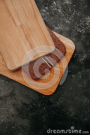 set of wooden cuttng boads on black background. Wooden kitchen block close up Stock Photo