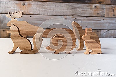 Set of wooden forest animals handmade. Waldorf toys on wooden background Stock Photo