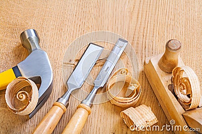 Set of woodworking tools chisel hammer plane on wooden board Stock Photo