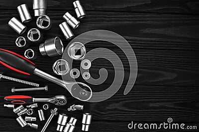 Set of wrenches, bolts and nuts on a wooden background. Stock Photo