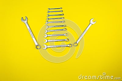 Set of wrenches of different sizes on a yellow background Stock Photo