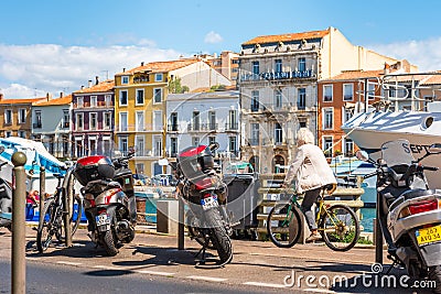 SETE, FRANCE - SEPTEMBER 10, 2017: Cyclist on the city waterfront. Copy space for text Editorial Stock Photo