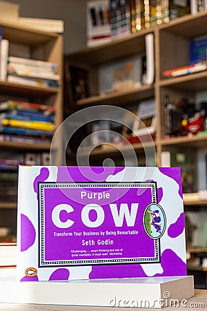 Seth Godin's Purple Cow, New Edition: Transform Your Business by Being Remarkable book in the bookshop. Editorial Stock Photo