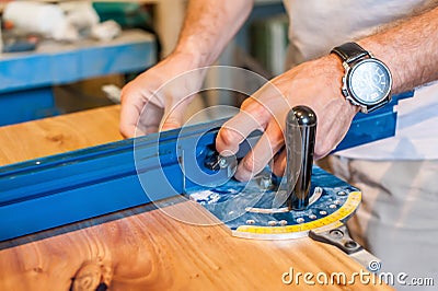 Setquare. angle. Hands of a worker with a measuring tool in a carpentry workshop. Large paln Stock Photo