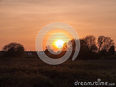 Setting Sun with Milky And Wavy clouds Stock Photo