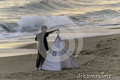 Setting up the wedding shoot, twilight on the beach with tent Editorial Stock Photo