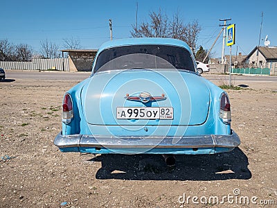 Blue old soviet car GAZ M21 Volga / GAZ-21 oldtimer parked on the road in spring sunny weather Editorial Stock Photo