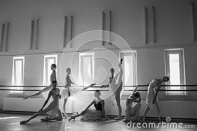 The seven ballerinas at ballet bar Stock Photo