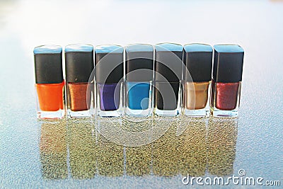 Seven bottles of nail polish on a table Stock Photo