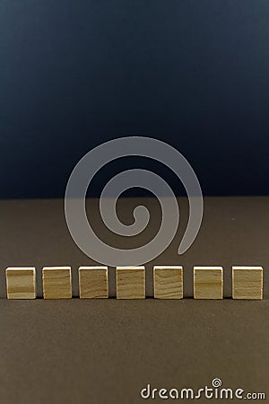 Seven children wooden blocks in line, portrait Stock Photo