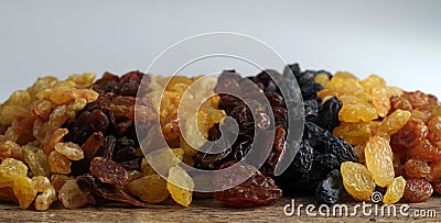 Seven different varieties of raisins are placed in rows. Stock Photo